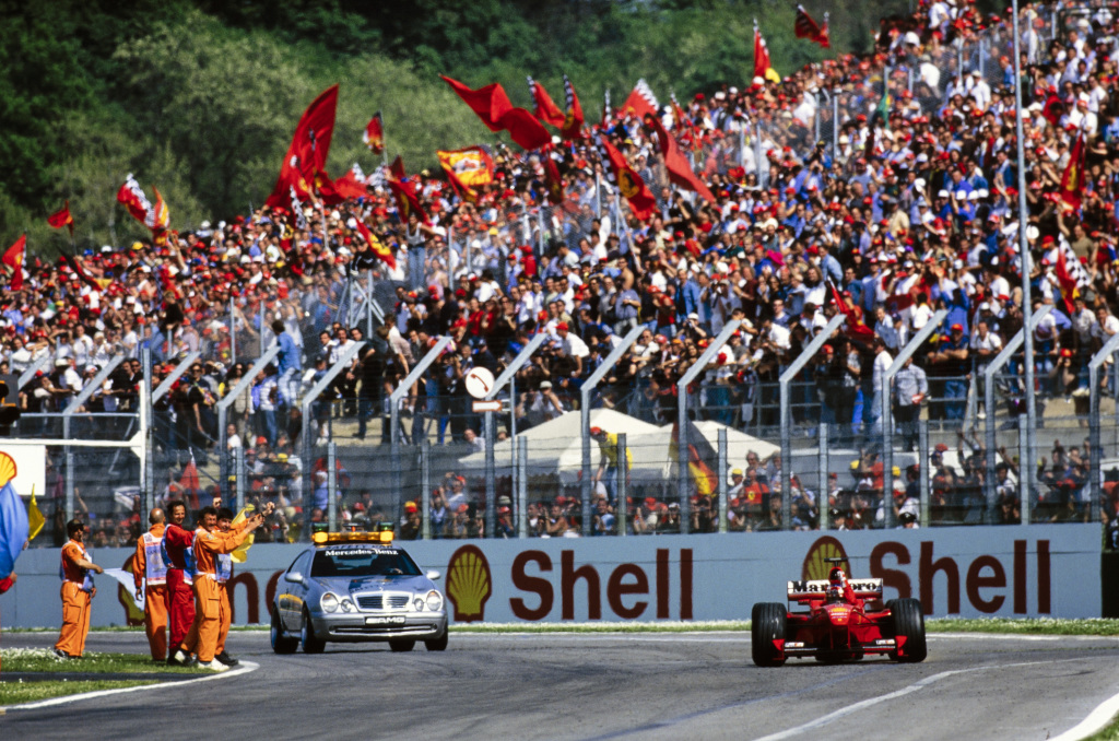 Fans celebrate as Michael Schumacher wins an F1 race at Imola.

