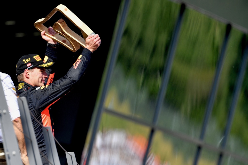 Formula 1 driver Max Verstappen holds the winner's trophy aloft