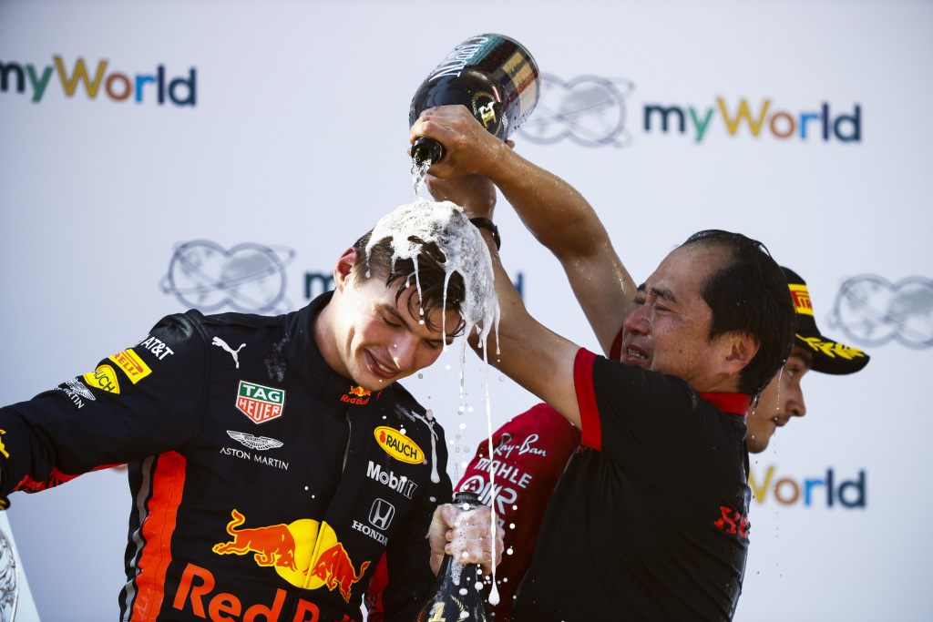 Champagne is poured on the head of Max Verstappen