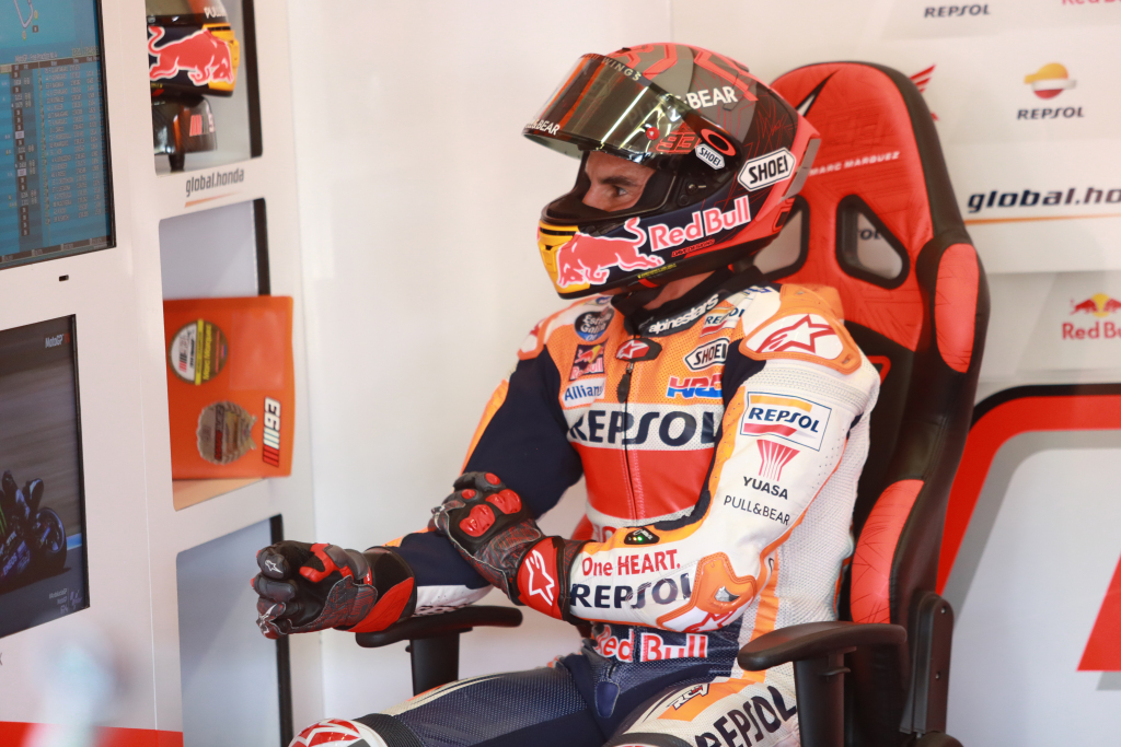 Moto GP rider Marc Marquez holds his arm after suffering an injury