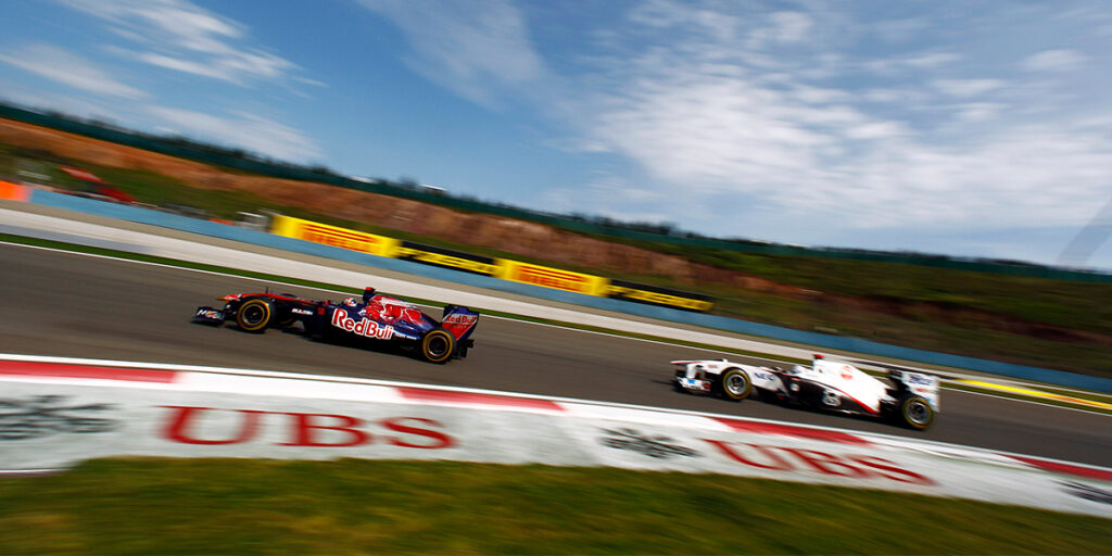 Two Formula 1 cars drive around a corner at the Turkish Grand Prix