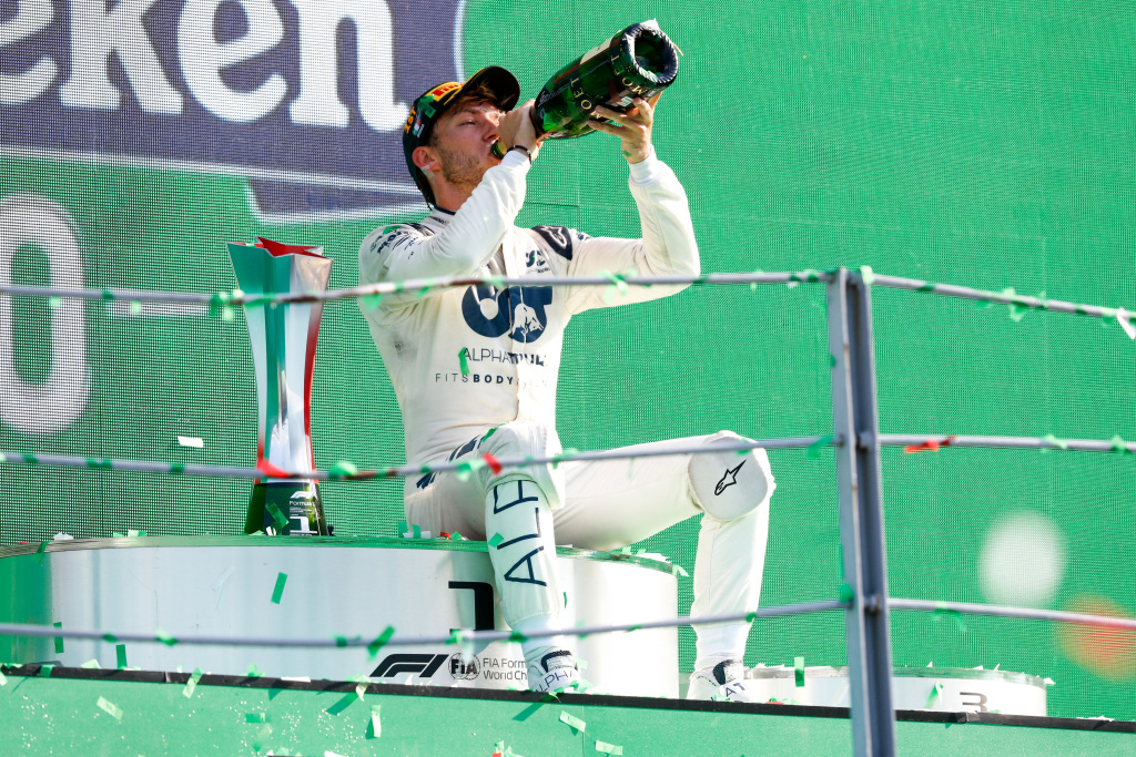 F1 driver Pierre Gasly drinks champagne on the podium after winning a race