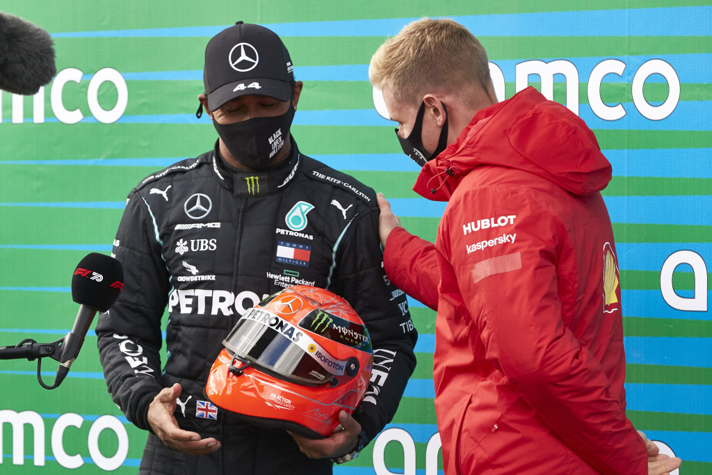 Lewis Hamilton is gifted Michael Schumacher's helmet by Mick Schumacher.