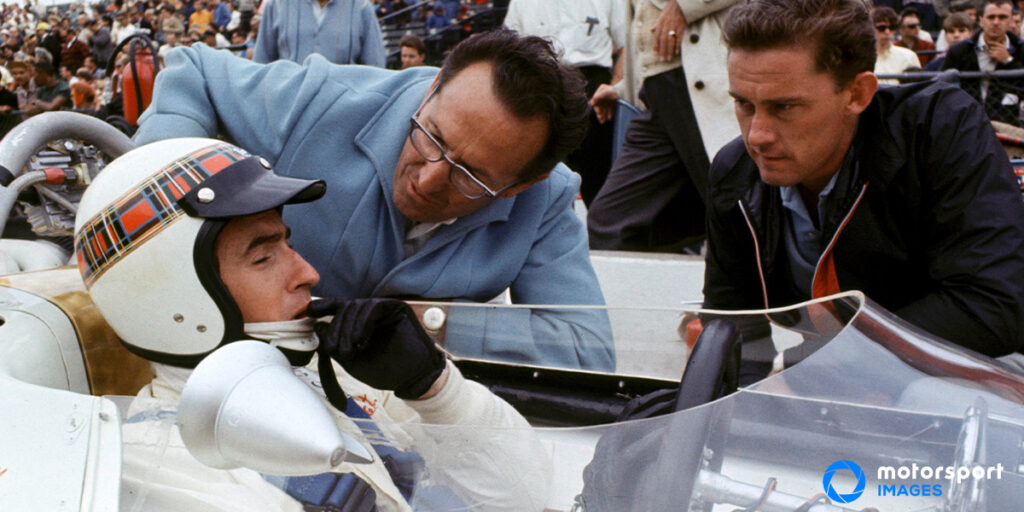 Mechanics talking to F1 driver Jackie Stewart