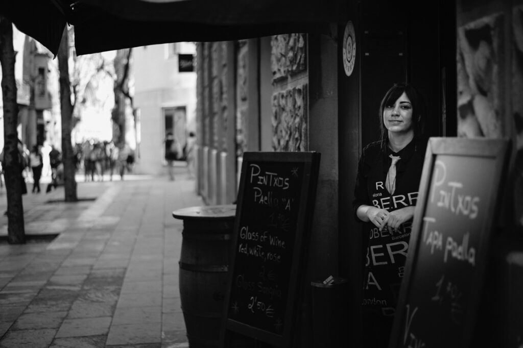A waitress outside a bar in Barcelona