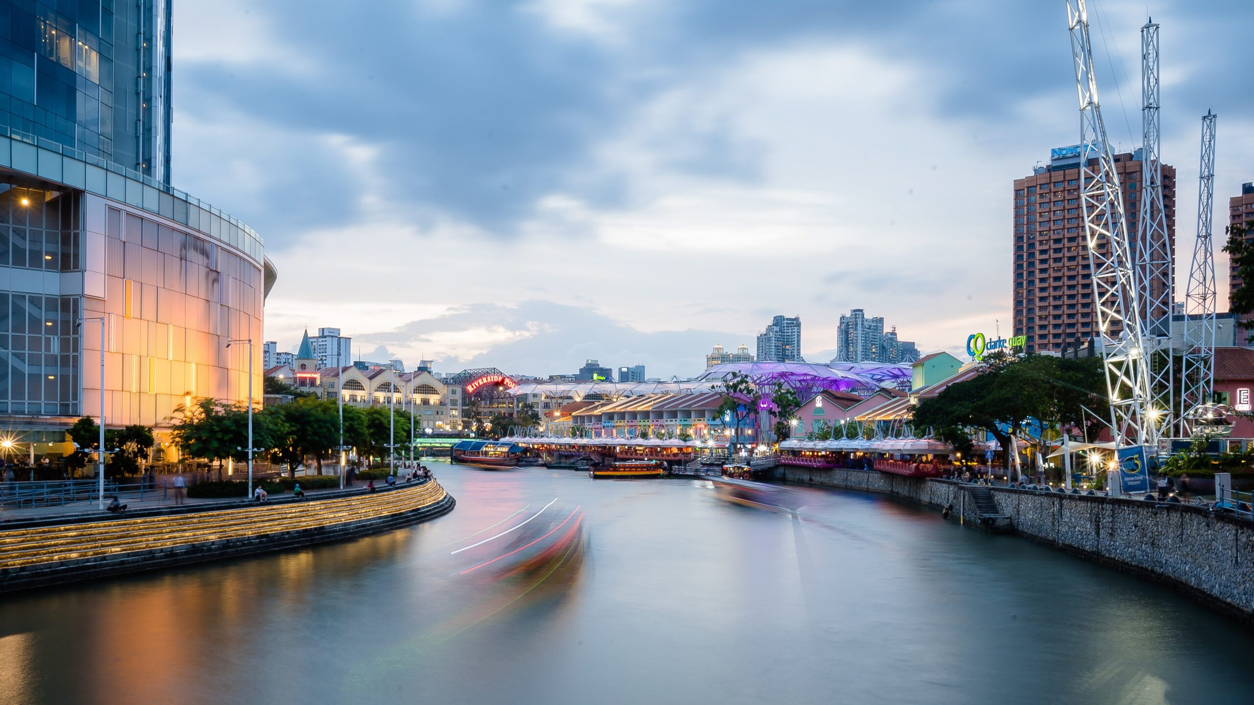Boats speed along the Singapore river