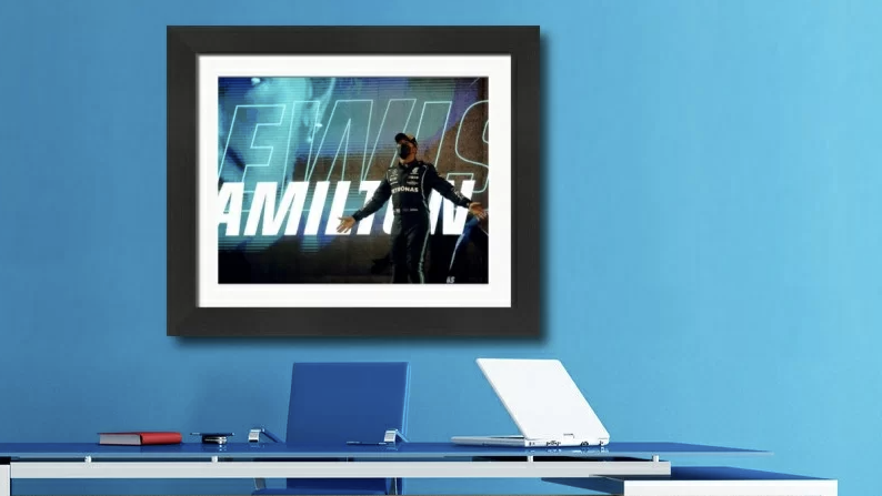 A Lewis Hamilton print behind a desk