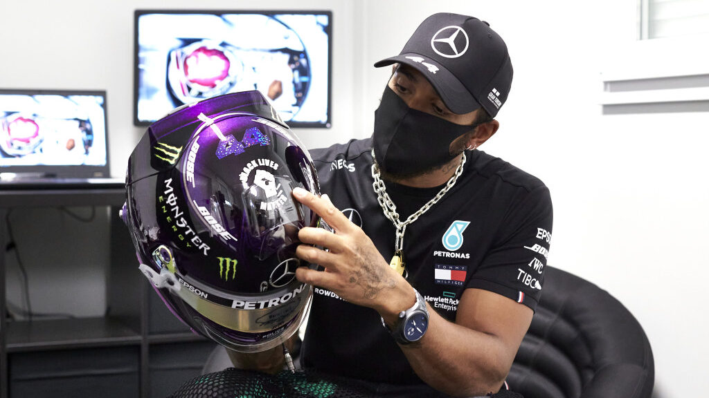 Lewis Hamilton holding his helmet