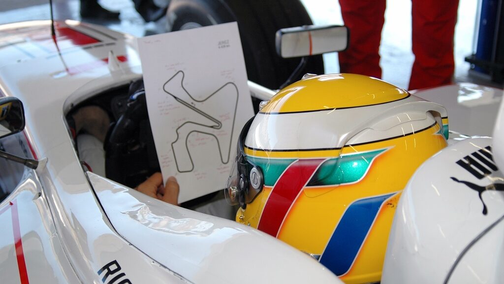 A driver studying a circuit map