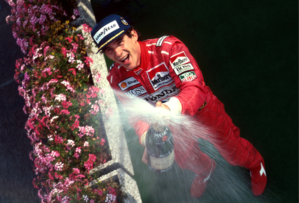 Ayrton Senna sprays champagne on a Formula 1 podium