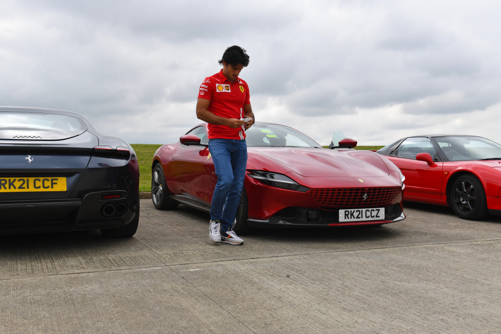 Carlos Saniz parks a Ferrari in a car park at Silverstone