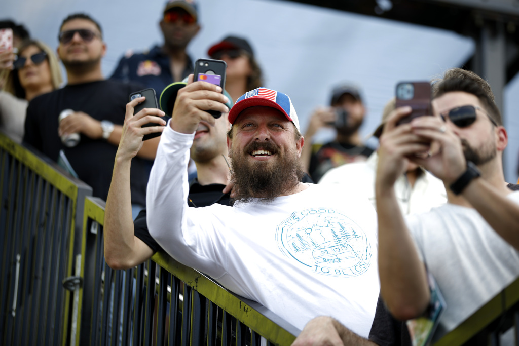 A fan taking a photo of a Formula 