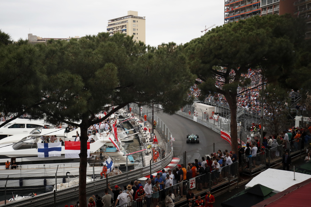 Fans watch Sebastian Vettel drive his Aston Martin Formula 1 car past yachts in Monte Carlo, Monaco.