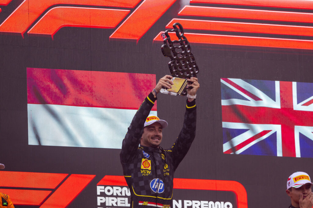 Ferrari's Charles Leclerc lifts the winners trophy at the Italian Grand Prix 2024